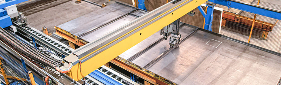 Precast Manufacturing Facility with Yellow Overhead Cranes and Blue Automated Production Equipment